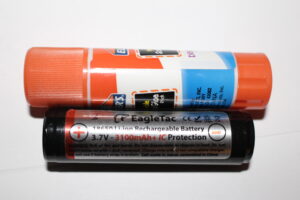 A typical 18650 battery compared in size to a typical glue stick!