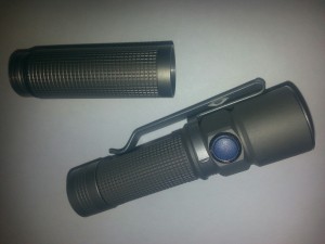 Olight S15 shown with its extender